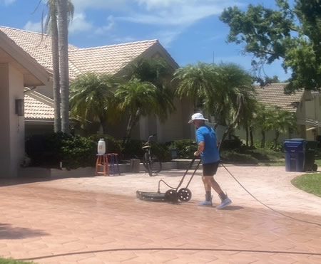 Technician performing oil stain removal on a st petersburg driveway